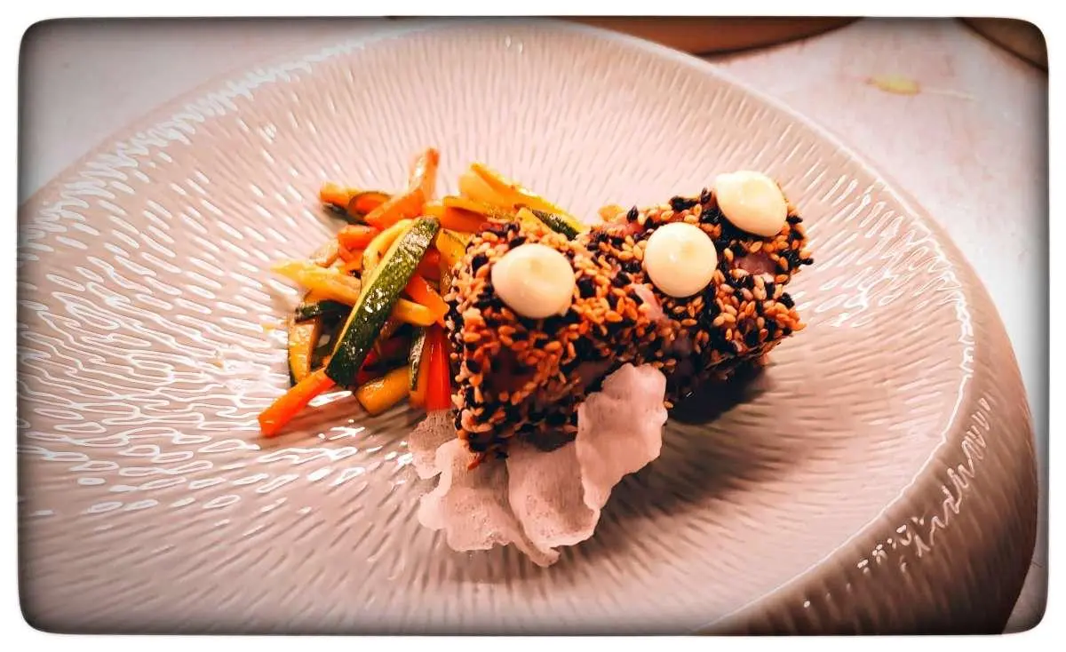 Omnia yacht with plated dish of meat and vegetables on table