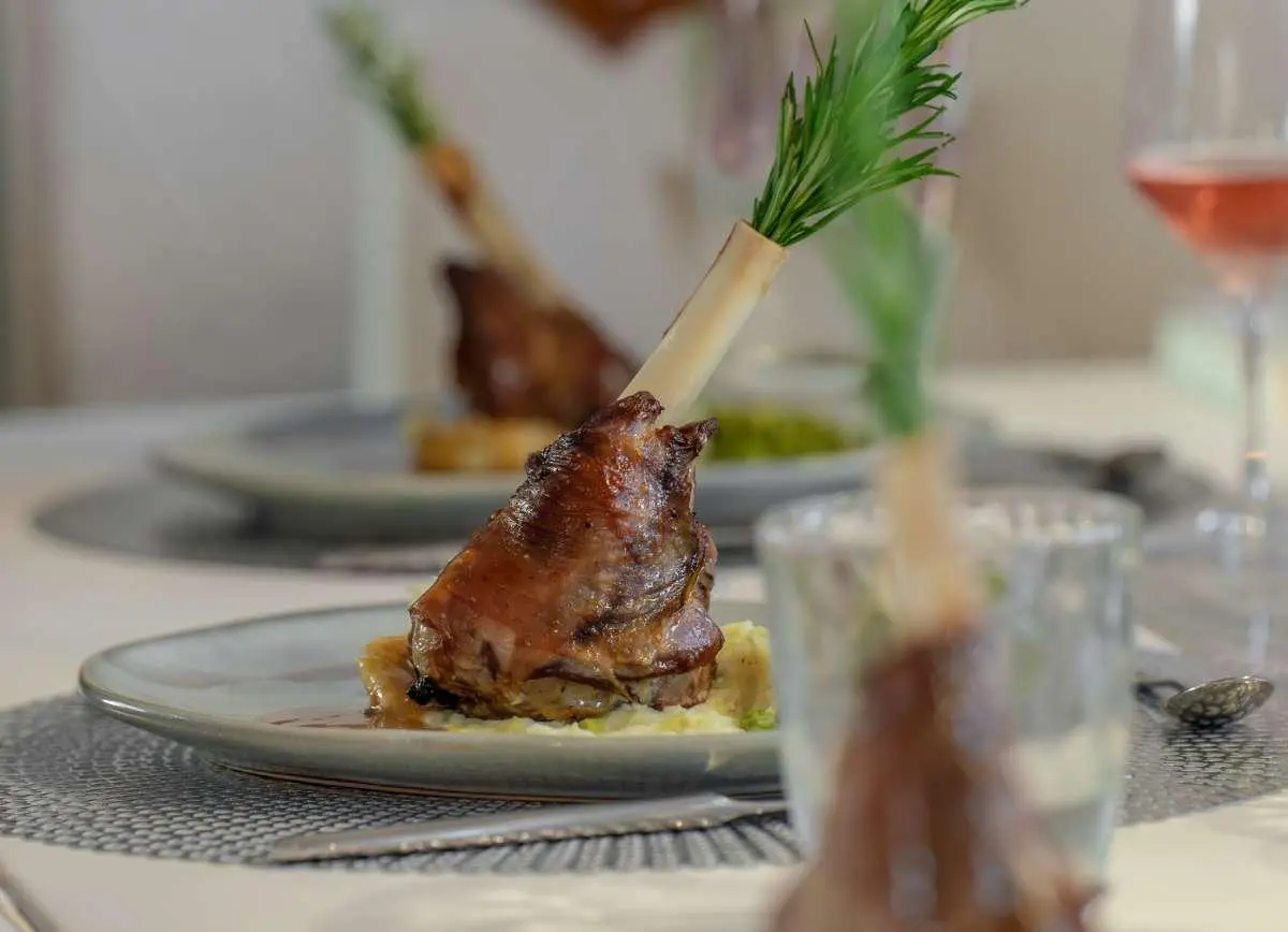 Close-up of a plated dish aboard Cristal yacht with garnish and table setting