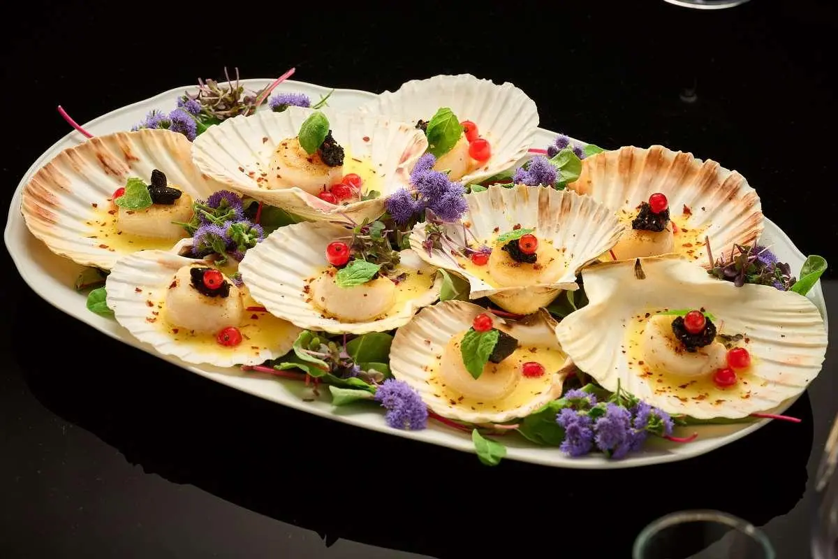 Queen Eleganza yacht deck with plated canapés arranged on a platter