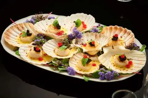 Queen Eleganza yacht deck with plated canapés arranged on a platter