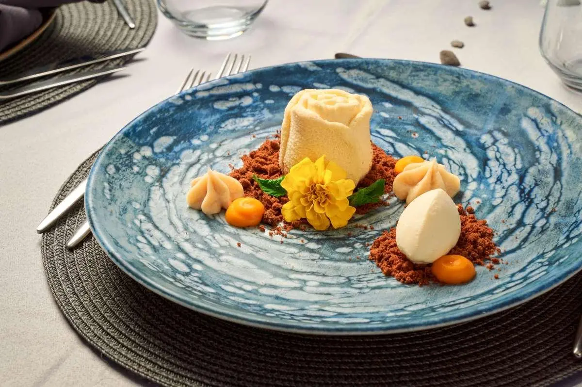 Plate with cheese, fruit, and nuts on a blue patterned plate aboard Lupus Mare yacht
