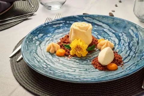 Plate with cheese, fruit, and nuts on a blue patterned plate aboard Lupus Mare yacht