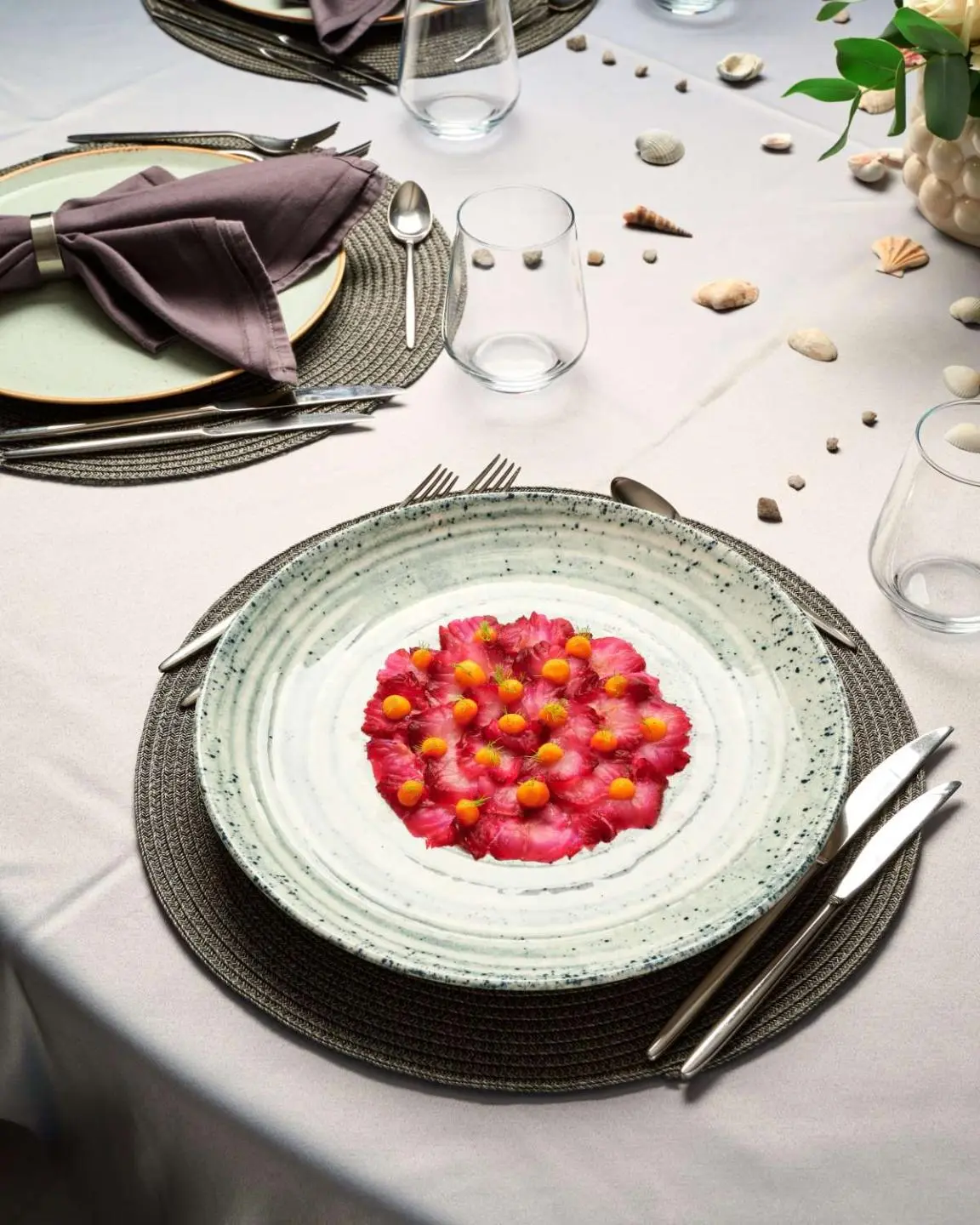 Lupus Mare yacht dining table set with plate of pomegranate adornments