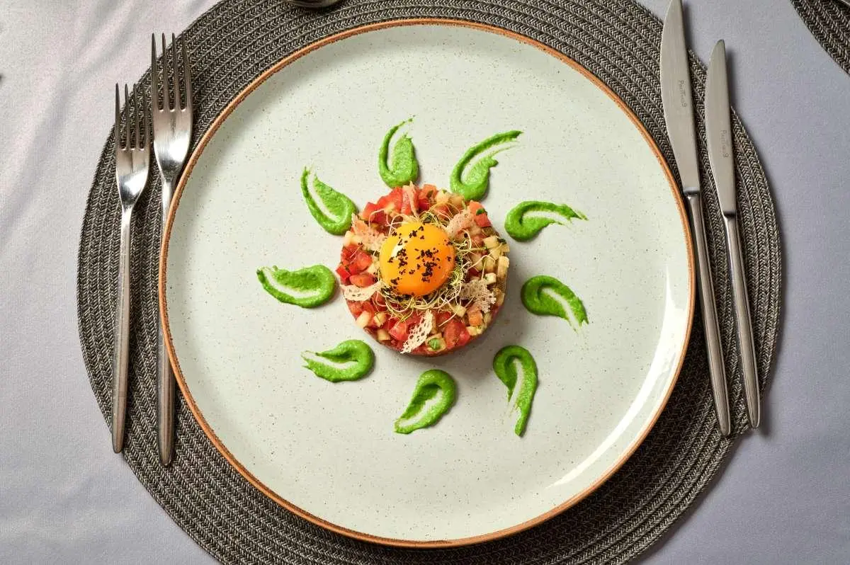 A round plate with a sunburst fruit and leaf design aboard Lupus Mare yacht