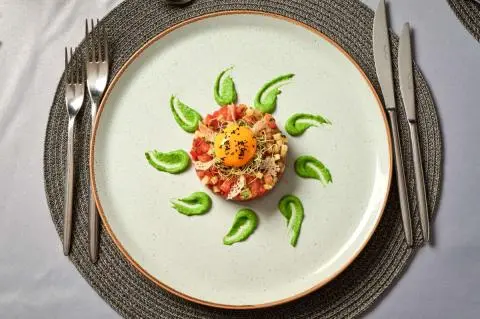 A round plate with a sunburst fruit and leaf design aboard Lupus Mare yacht