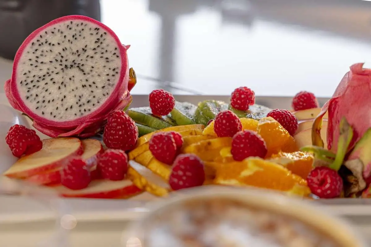 Karizma yacht kitchen counter with fresh fruit platter and sliced dragon fruit