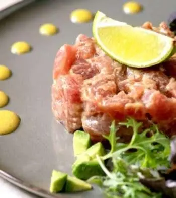 Navilux yacht scene with plated meal and garnish on table onboard