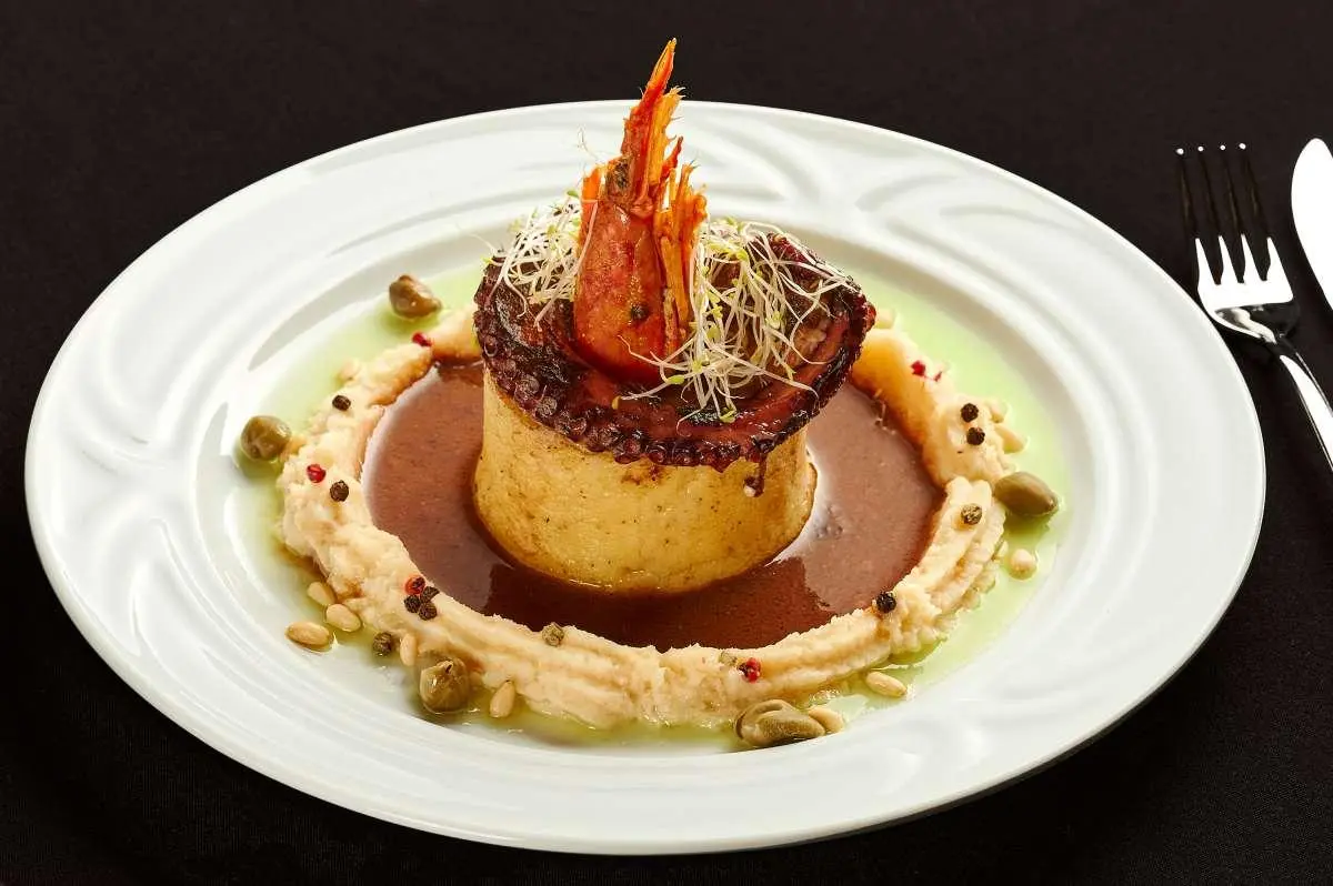 Luna yacht dining scene featuring a plated dessert garnish and sauce