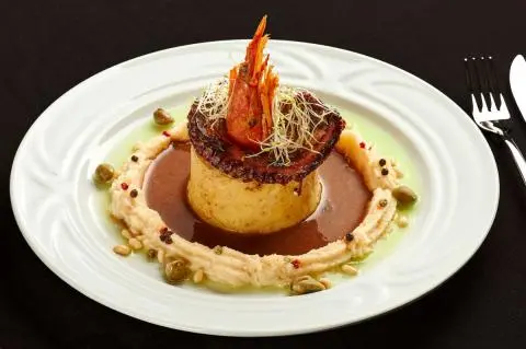 Luna yacht dining scene featuring a plated dessert garnish and sauce