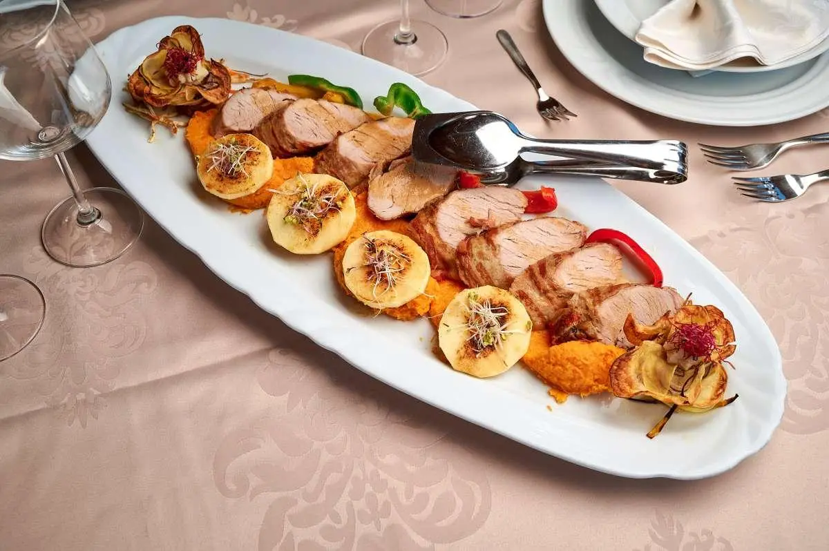 Luna yacht menu items arranged on a white platter with skewers and sauces