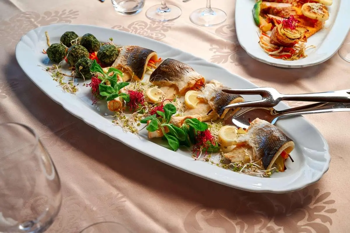 Luna yacht scene with a long platter of skewered tapas on a table