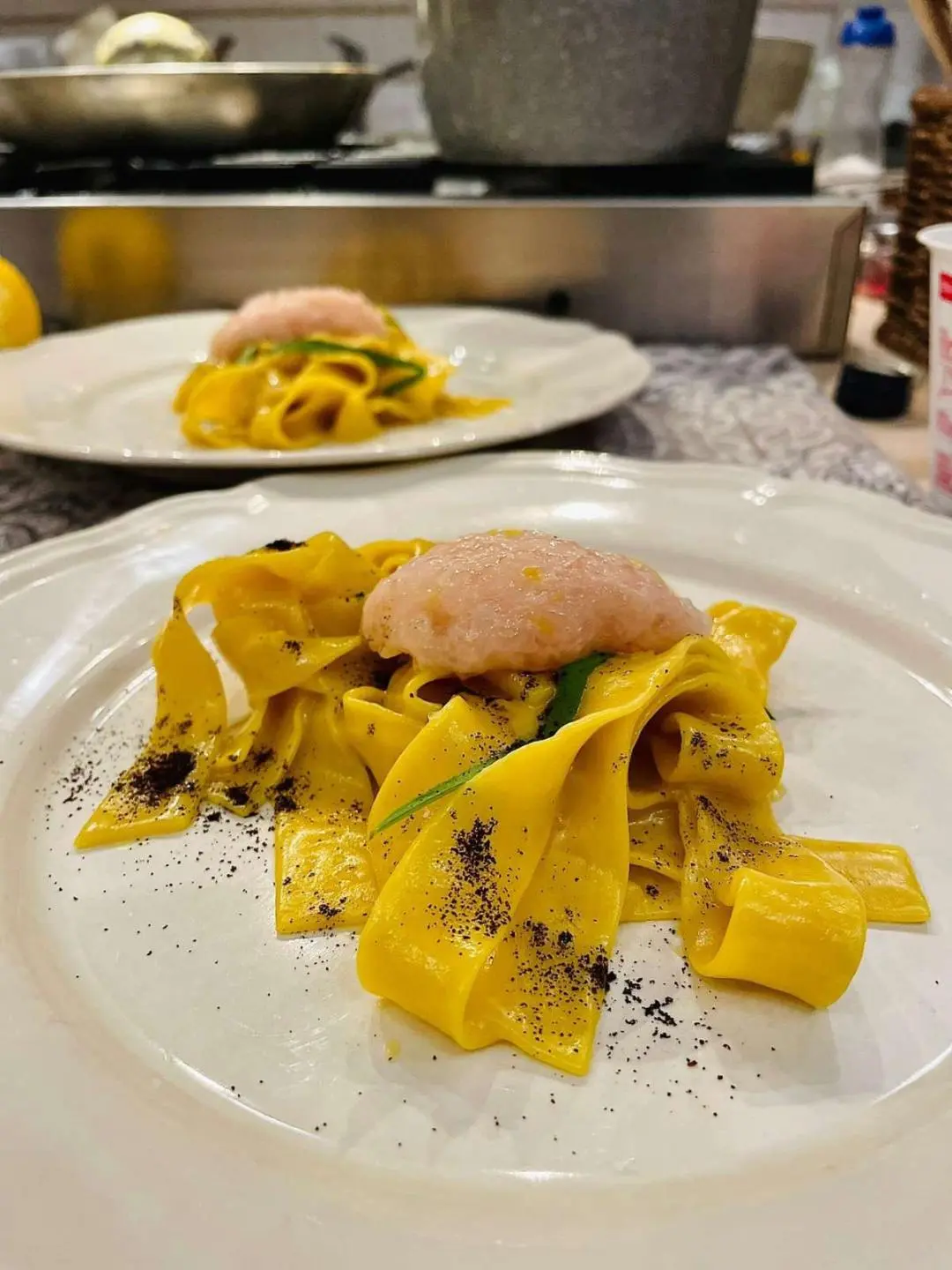 Genny yacht scene with plated pasta pasta dish and lemon wedges on table