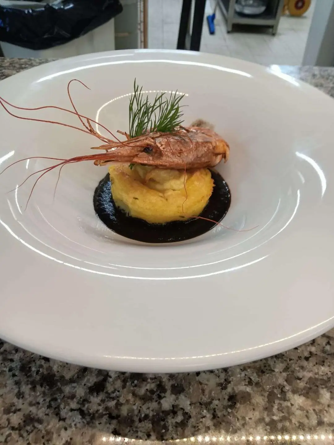 Genny yacht in harbor with plated appetizer on white plate in foreground