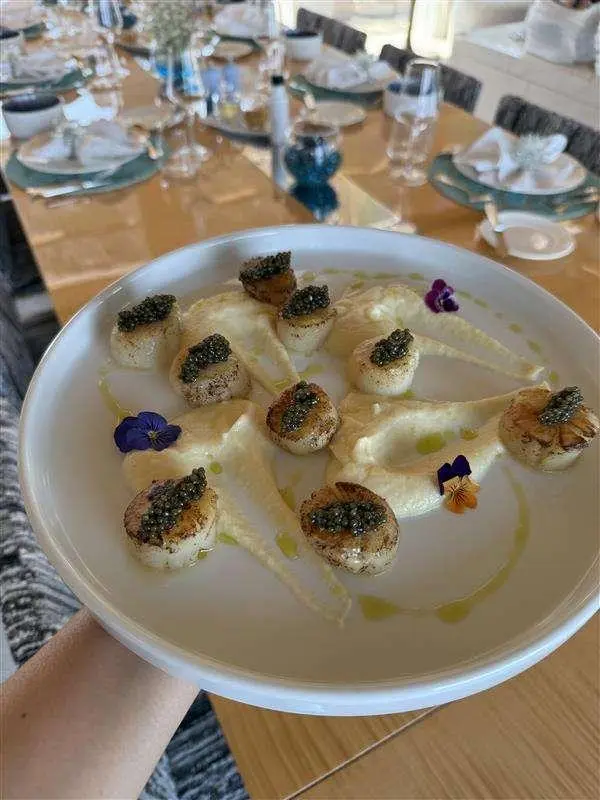 Yacht La Pellegrina 1 dining scene with small shells on a round plate