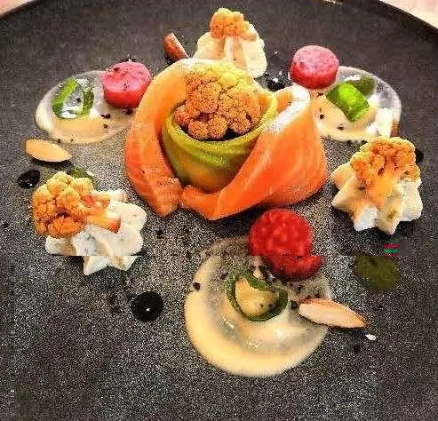 Cartouche yacht menu display with orange fruit and assorted light bites on slate