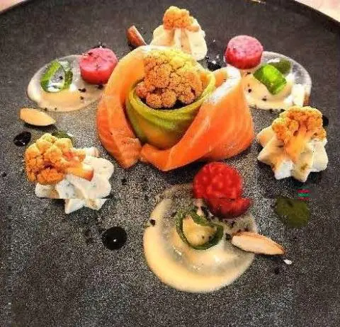 Cartouche yacht menu display with orange fruit and assorted light bites on slate