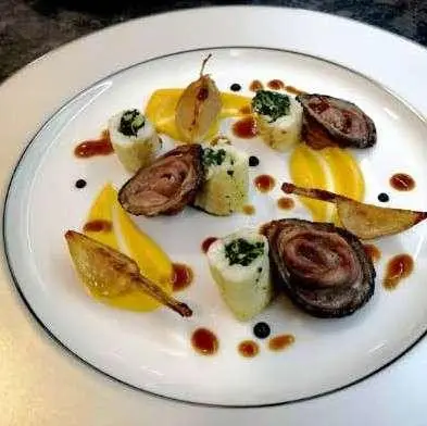 Cartouche yacht meal on deck with plated course dishes and sauces