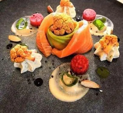 Cartouche yacht menu spread with fruit, pastries, and plated dishes on table