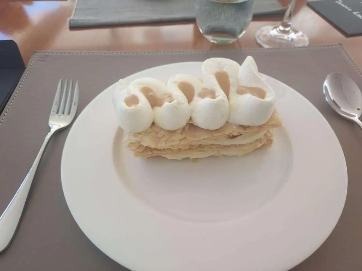 Yacht Just Marie 2 plate with a dessert topped with cream and berries on deck