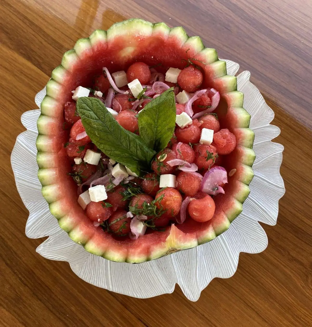 Christal Mio yacht charter scene with a dining table and fruit platter on deck