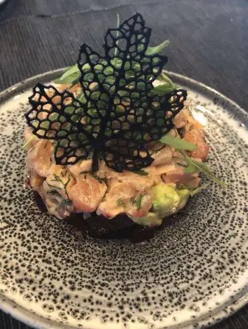 Astoria yacht charter dish with tuna tartare plated on dark textured plate