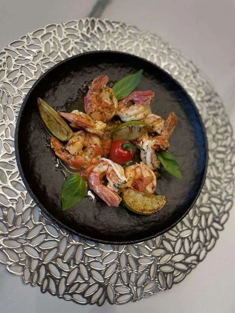 Astoria yacht menu plate with colorful fruits and herbs on dark dish