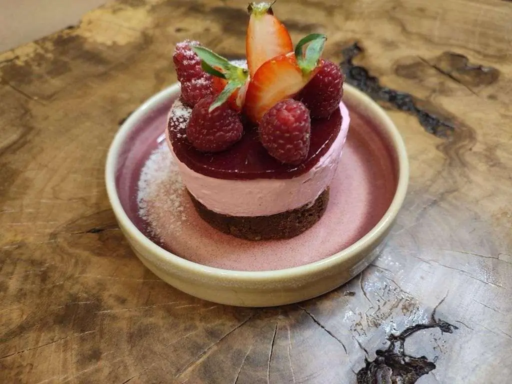 Astoria yacht with a small pink dessert and fruit garnish on deck
