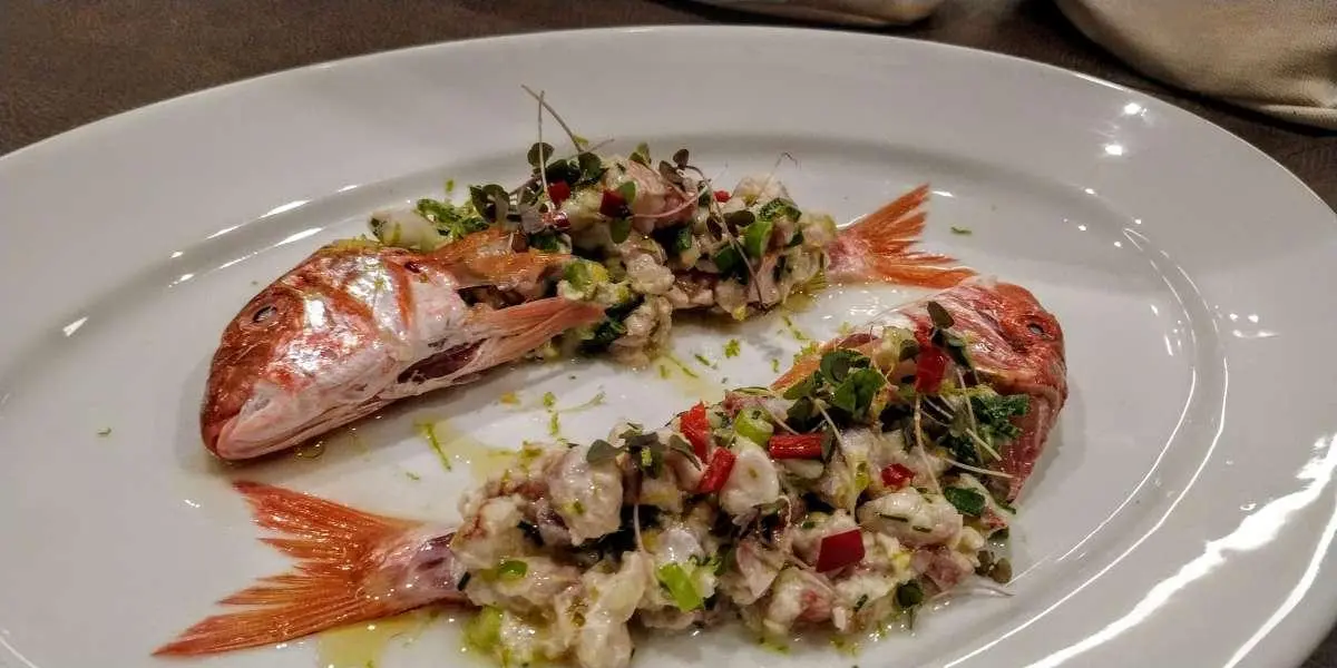 Atlantis yacht charter image showing a plate of mixed seafood dishes on a wooden table
