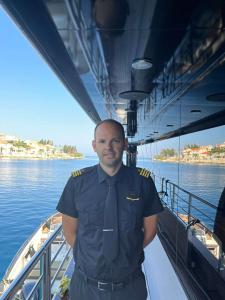 Crew Officer On Yacht Deck Harbor Background