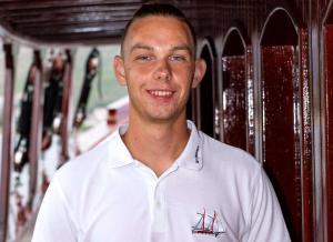 Young Crew Member White Polo Yacht Cabin