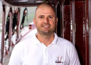 Crew Member Portrait On Wooden Yacht Deck