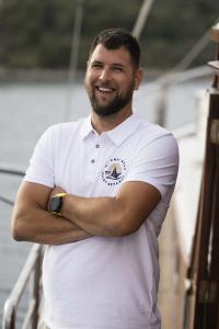 Smiling Crew Member White Polo Deck