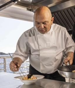 Chef Plating Seafood On Yacht Deck