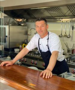 Chef Leaning On Kitchen Counter