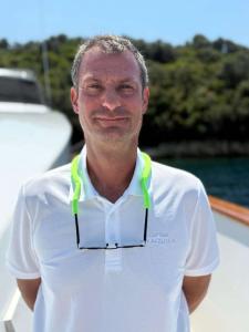 Man In White Polo On Yacht Deck