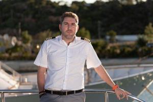 Captain Crew Leaning On Yacht Rail