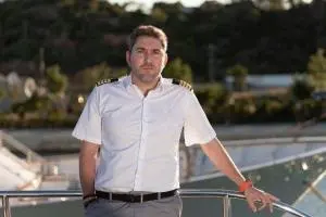 Captain Crew Leaning On Yacht Rail