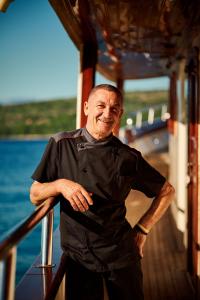 Smiling Ship Chef Leaning On Yacht Rail