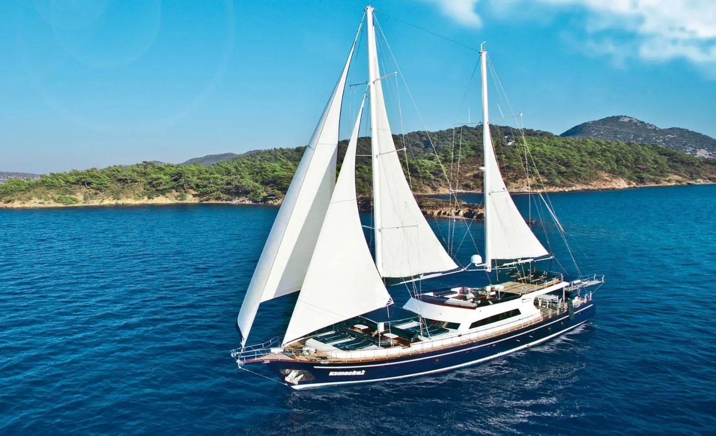 Maske 2 gulet sailing boat with white sails on blue sea