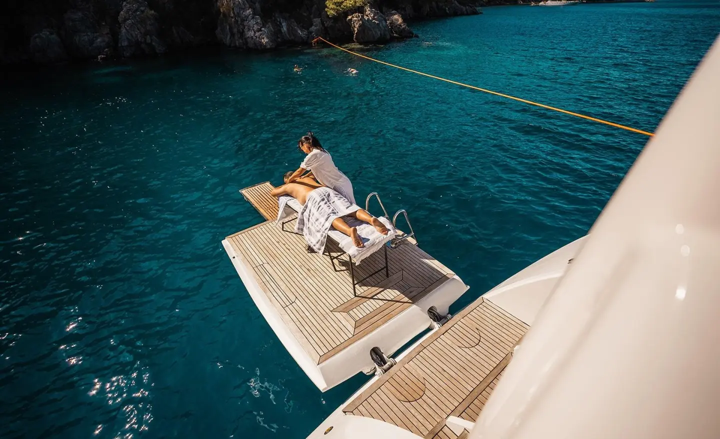 Gulet Angelo III yacht on a swim platform with people sunbathing