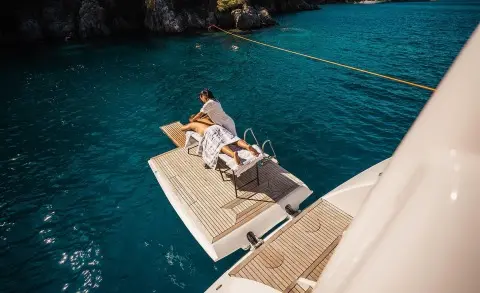 Gulet Angelo III yacht on a swim platform with people sunbathing