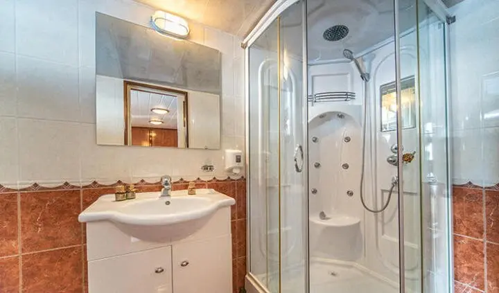 Luna yacht cabin interior with glass shower enclosure and polished sink
