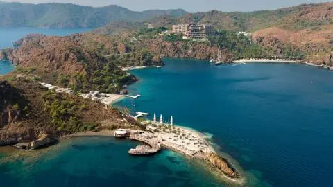 Coastal cove with docks and a small beach, several boats moored