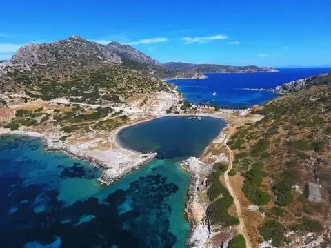 Aerial view of a small heart-shaped bay with rocky shores and clear turquoise water
