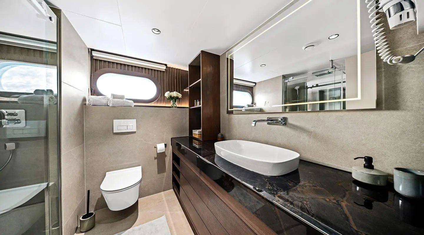 Anima Maris luxury yacht bathroom with bathtub, sink, and compact toilet