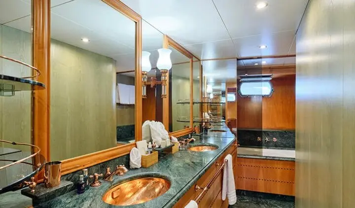 Mobius yacht master cabin with king bed, ensuite visible, wooden cabinetry