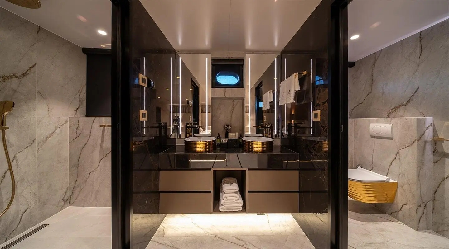 Nocturno yacht interior: luxurious bathroom with marble surfaces and mirror view