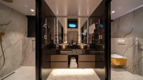 Nocturno yacht interior: luxurious bathroom with marble surfaces and mirror view