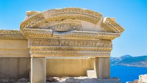 Detailed carved stone sarcophagus fragment with sea and islands beyond