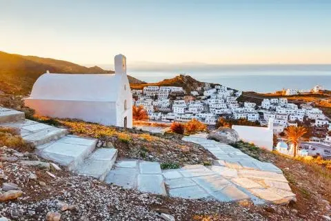 White-chapel-hill steps overlooking the Aegean Sea with a blue sky